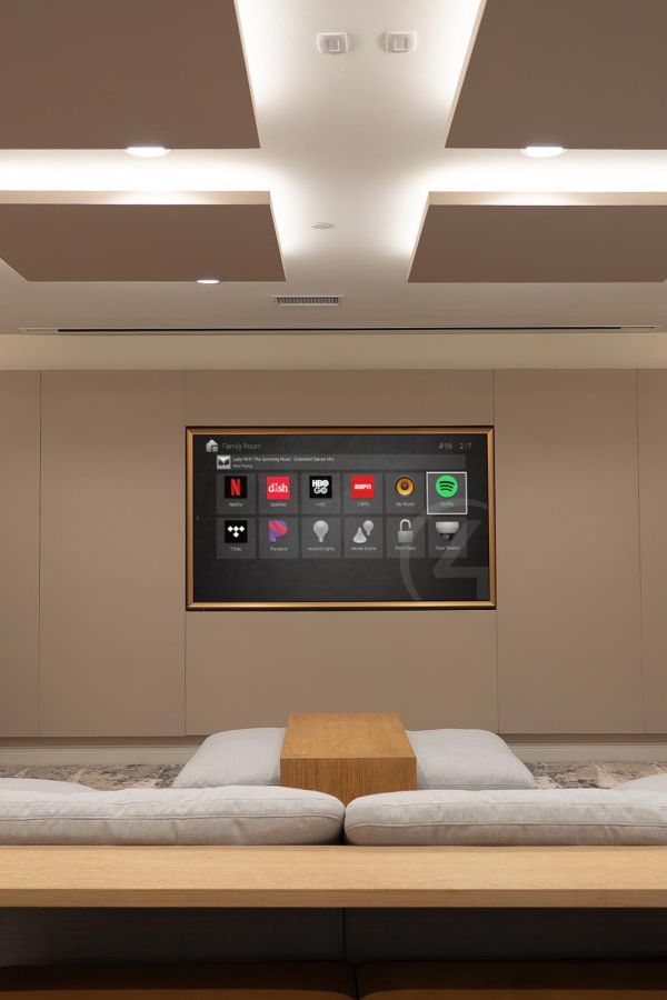 Minimalist home theater with recessed display wall and modern sectional seating