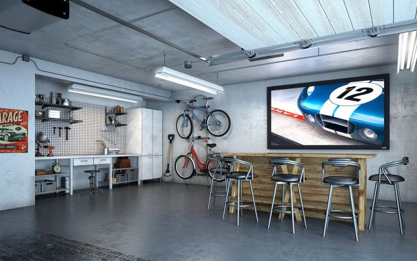 Garage with a huge TV and a bar with stools