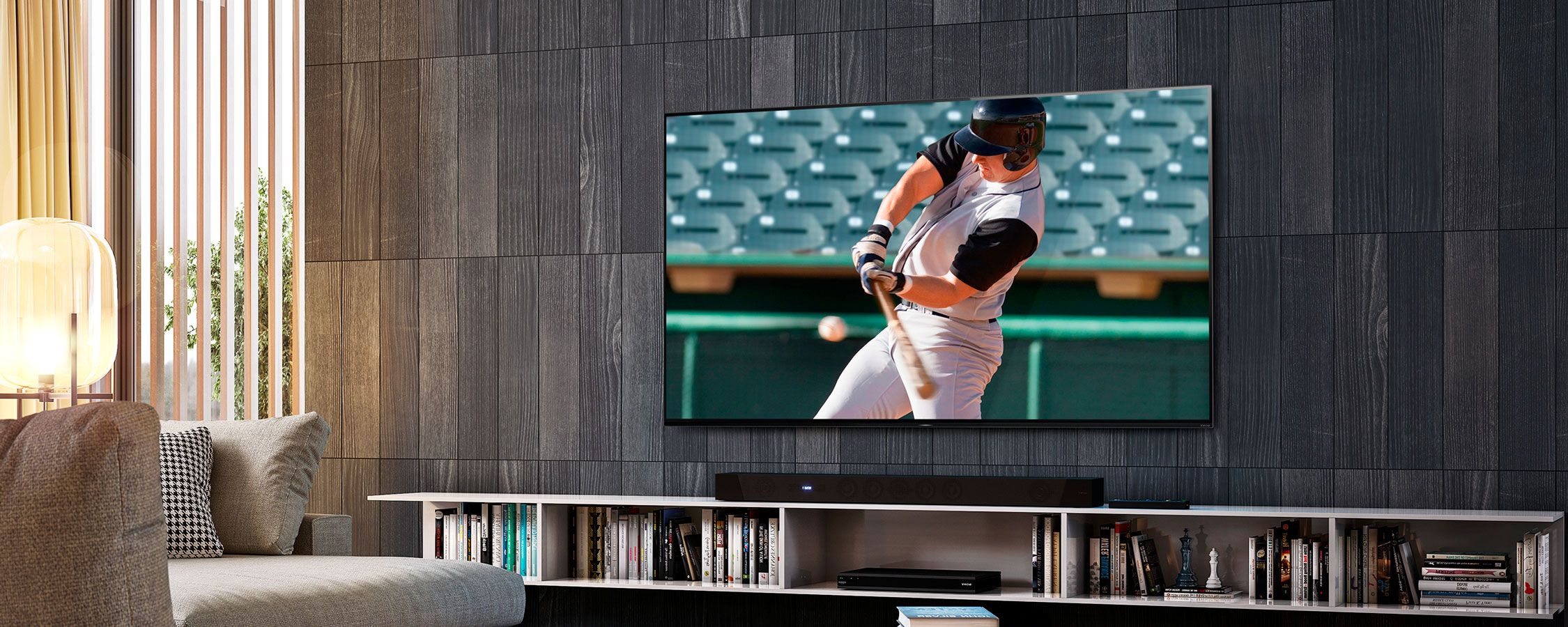 Sony TV in a dark wood wall with a soundbar 