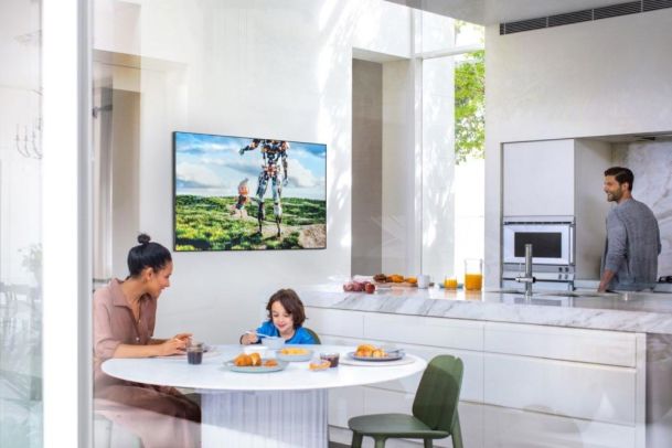 Samsung TV in a kitchen with people having breakfast